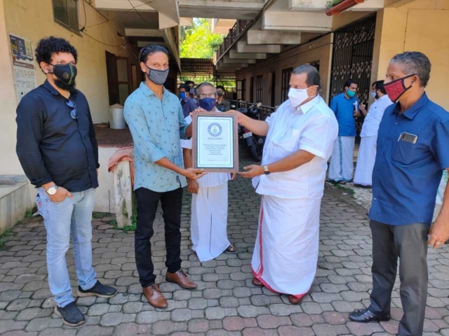 Receiving Guinness Record Certificate from Minister EP Jayarajan